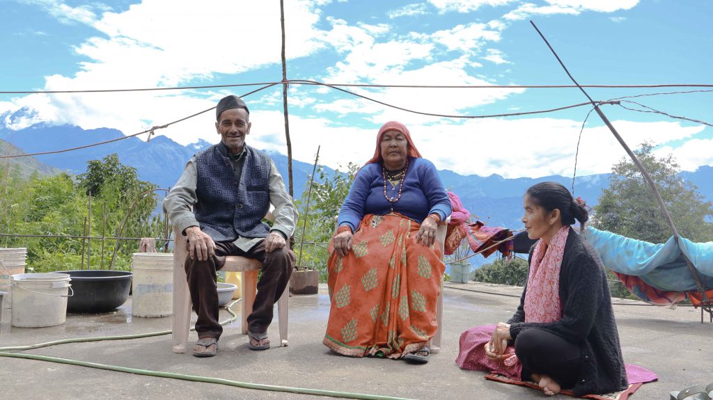 Chander Ram and his wife Haruli Devi sitting together in their courtyard, reflecting on their past.