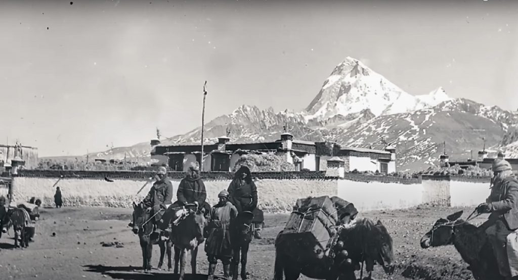 Historical image depicting the bustling trade activities between India and Tibet, showcasing merchants, goods, and the mountainous backdrop of the Himalayas.