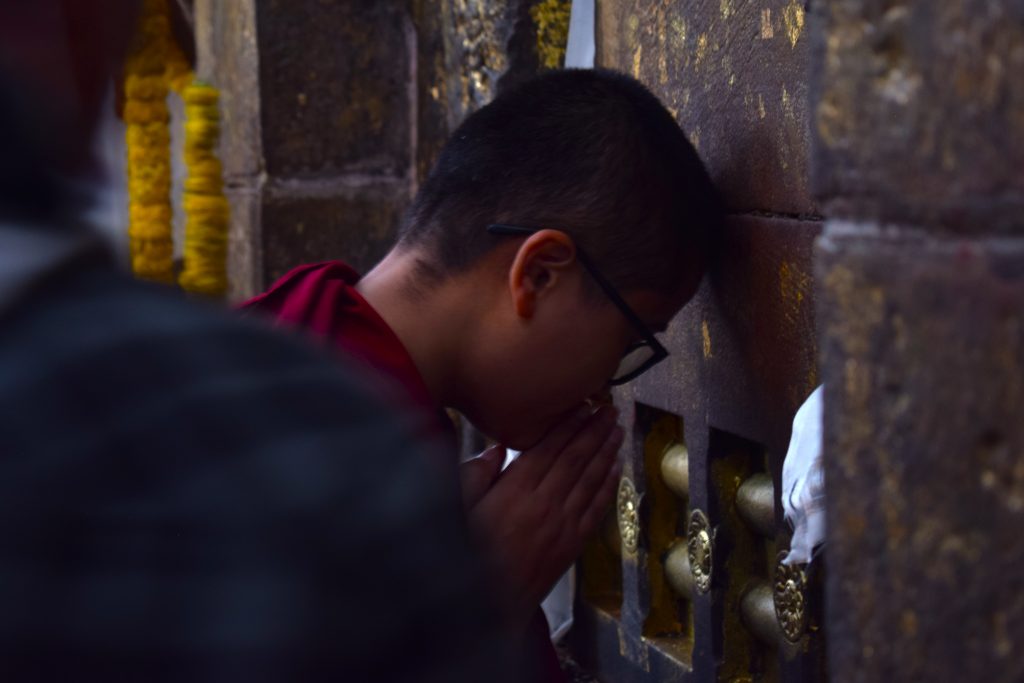 A Monk bowing down to Vajrayana (where Buddha attained enlightenment) in Mahabodhi Temple