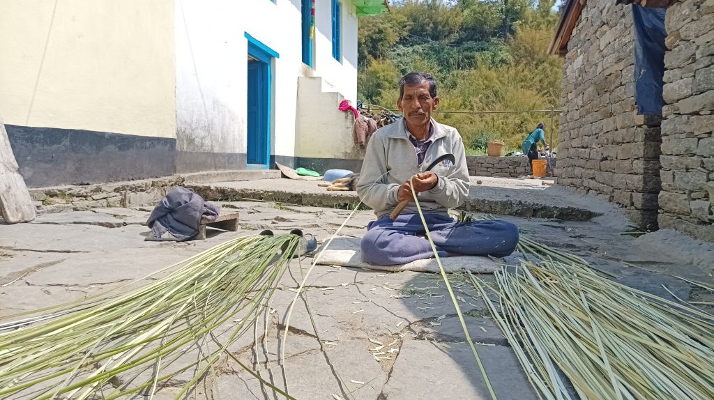 Dev Ram in the process of cutting fine strips of Ringal. Photo: Suresh