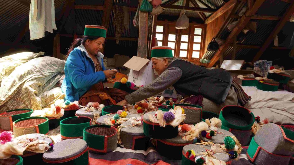 Women preparing topis to give to guests at a wedding. Photo: Tanisha Negi